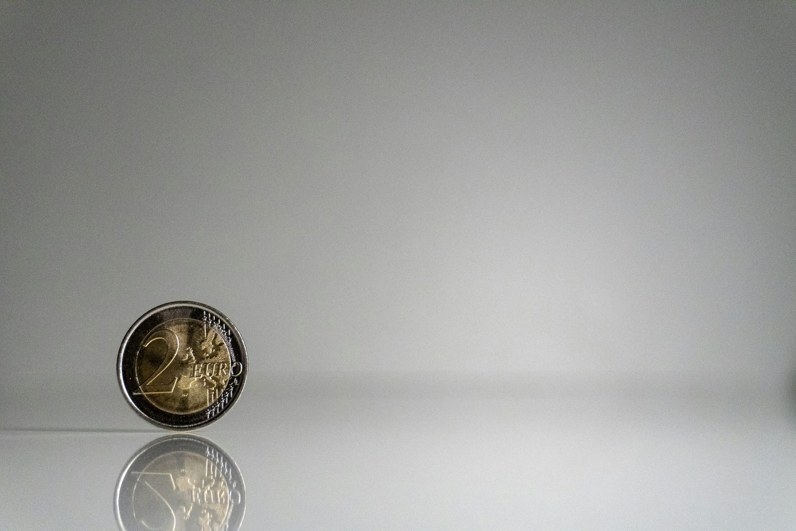 a close up of a coin on a reflective surface